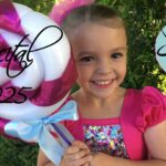 Little Girl dressed for Recital with large lollipop and Excel logo